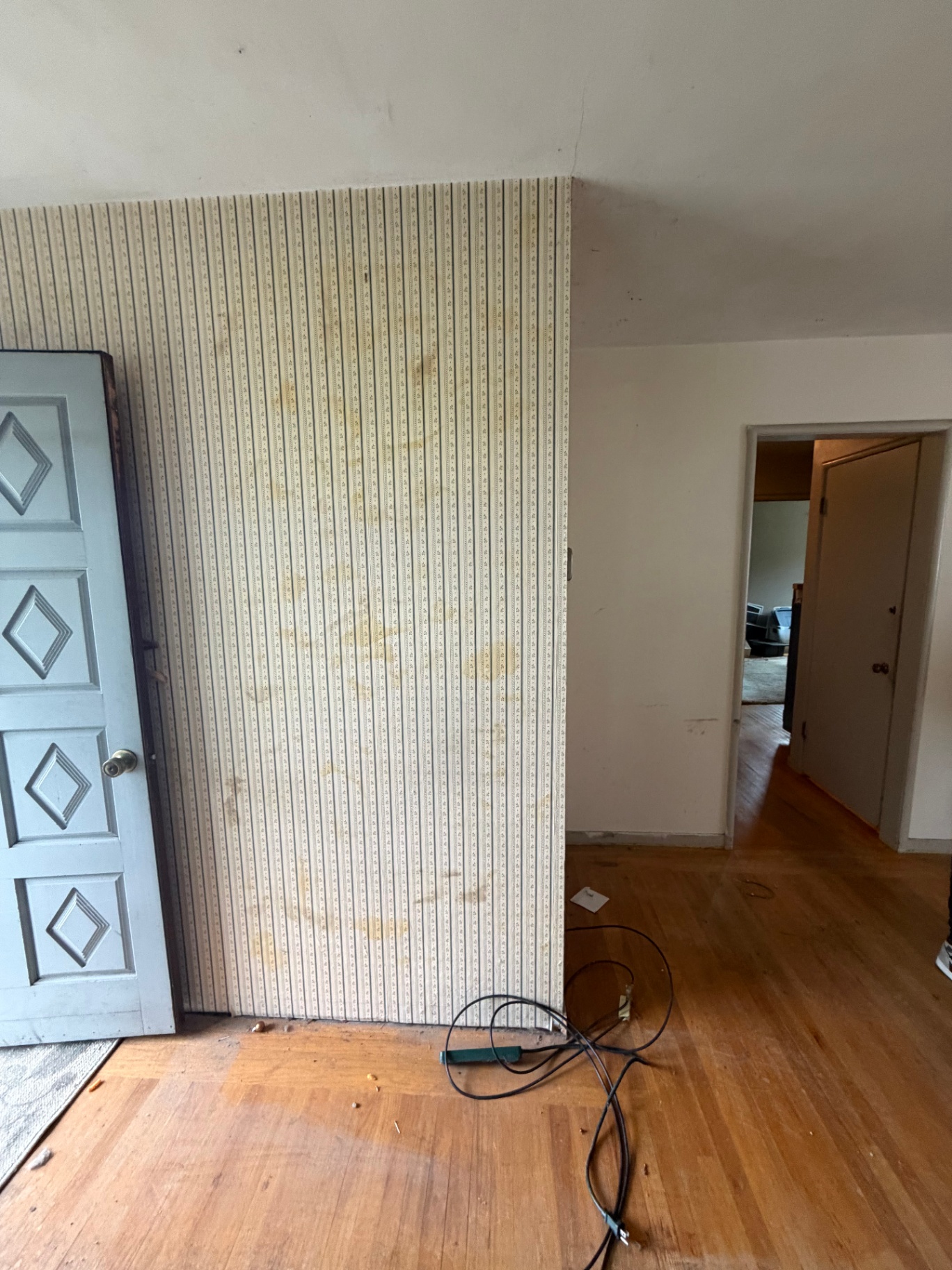 The same living room wall cleared after Greer Hauling removed the furniture