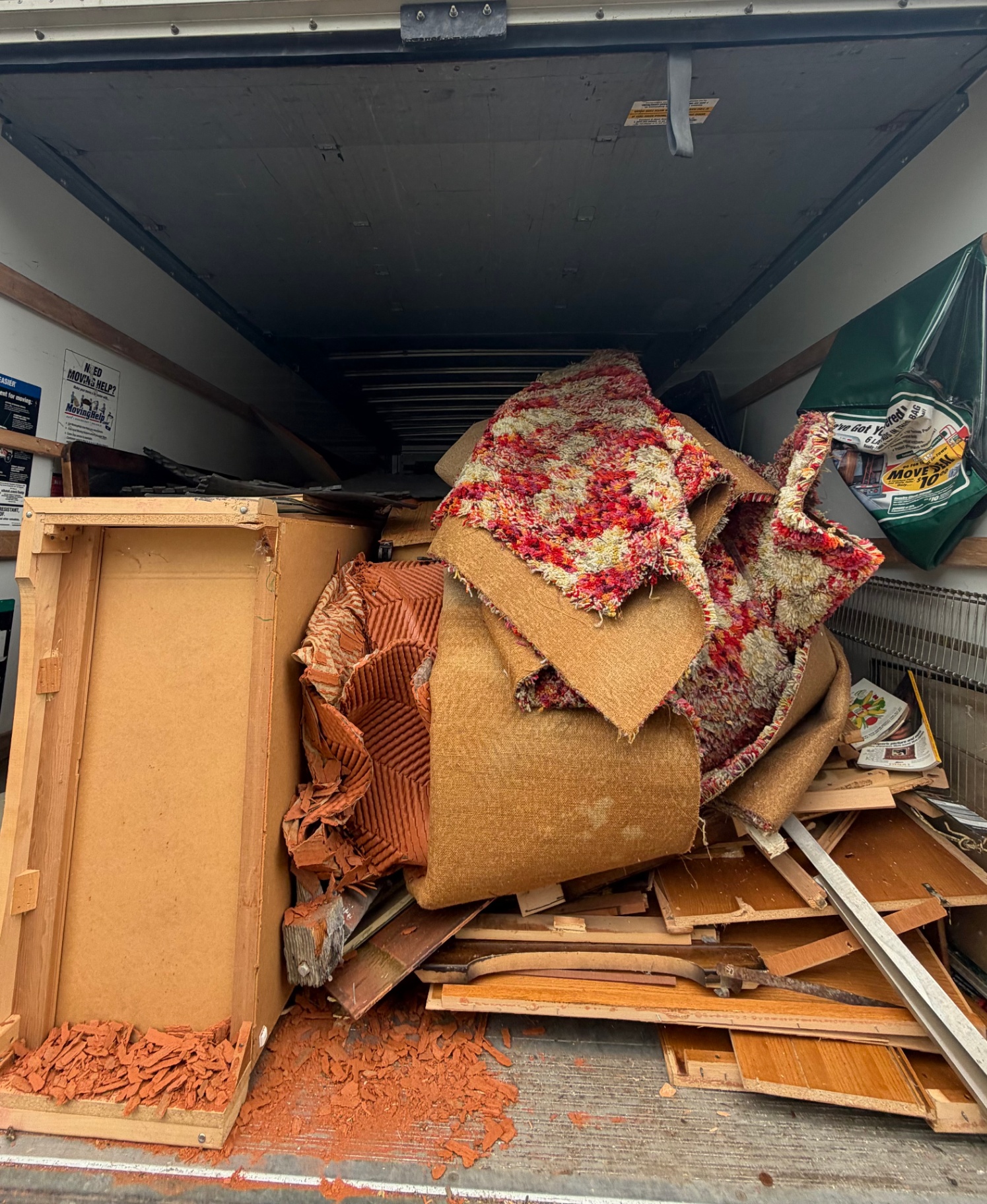 Greer Hauling truck loaded with old carpet, padding and demolition debris