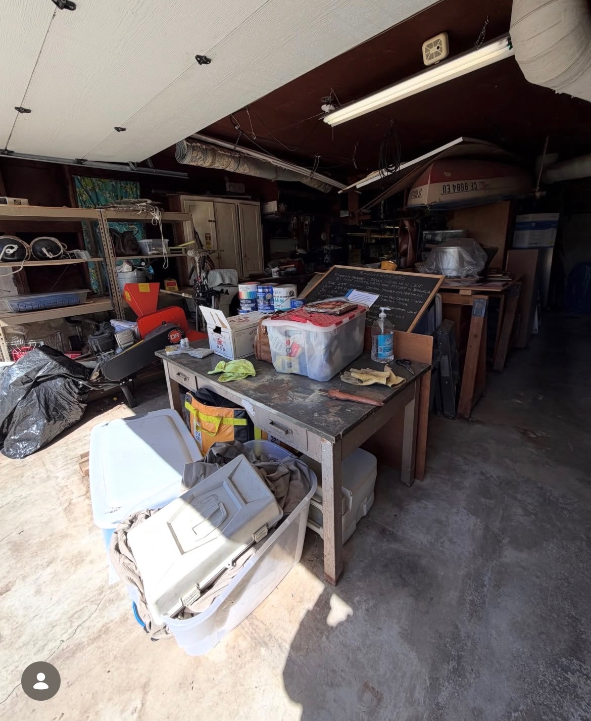 Bay Area garage packed with tools, boxes and clutter before a Greer Hauling cleanout