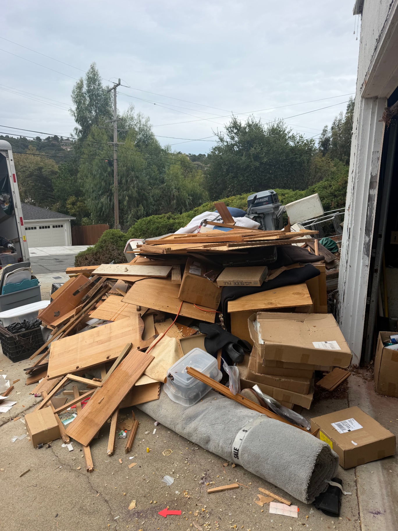 Pile of scrap wood, boxes and old carpet cleared out from a Bay Area garage for Greer Hauling